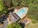Aerial view of pool, clubhouse, and playground, surrounded by green space and trees at 3531 Vintage Trl, Woodstock, GA 30189