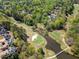 Picturesque aerial view of the golf course with green fairways and water features at 3531 Vintage Trl, Woodstock, GA 30189