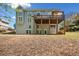 Expansive backyard featuring a covered deck with stairs leading down to the yard at 3531 Vintage Trl, Woodstock, GA 30189
