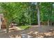 Large backyard surrounded by trees at 3531 Vintage Trl, Woodstock, GA 30189