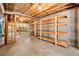 Spacious unfinished basement with open ceiling and wood shelving for storage at 3531 Vintage Trl, Woodstock, GA 30189
