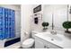 Functional bathroom with a vanity, toilet, and shower with a blue patterned curtain at 3531 Vintage Trl, Woodstock, GA 30189