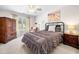 Bright bedroom featuring a ceiling fan, large window, and furnishings at 3531 Vintage Trl, Woodstock, GA 30189