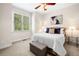 Serene bedroom with natural light, neutral colors, and a comfortable bed with decorative pillows at 3531 Vintage Trl, Woodstock, GA 30189