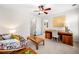 Bedroom with a seating area, ceiling fan, wooden desk, and an en suite bathroom at 3531 Vintage Trl, Woodstock, GA 30189