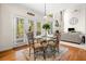 Bright breakfast nook with large windows, glass table, and hardwood flooring at 3531 Vintage Trl, Woodstock, GA 30189