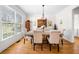 Bright dining room with hardwood floors, large window, and an elegant chandelier at 3531 Vintage Trl, Woodstock, GA 30189