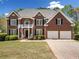 Beautiful brick home featuring a well-manicured lawn, 2-car garage, and a charming front porch at 3531 Vintage Trl, Woodstock, GA 30189
