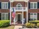 Detailed front porch with an American flag, white columns and charming outdoor seating at 3531 Vintage Trl, Woodstock, GA 30189