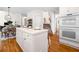 Open-concept kitchen with white island, hardwood floors, and stainless steel double ovens at 3531 Vintage Trl, Woodstock, GA 30189