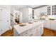 Bright kitchen featuring white cabinets, a center island, and stainless steel appliances at 3531 Vintage Trl, Woodstock, GA 30189