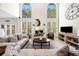 Elegant living room with large windows, fireplace, and comfortable seating area at 3531 Vintage Trl, Woodstock, GA 30189