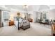 Spacious main bedroom with a sitting area, desk nook, and a large window at 3531 Vintage Trl, Woodstock, GA 30189