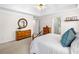Bright main bedroom featuring a tray ceiling, dressers, and neutral decor at 3531 Vintage Trl, Woodstock, GA 30189