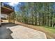 View of the patio overlooking the backyard surrounded by lush trees at 3531 Vintage Trl, Woodstock, GA 30189