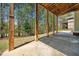 View of the patio overlooking the backyard surrounded by lush trees at 3531 Vintage Trl, Woodstock, GA 30189