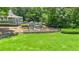 Beautiful playground in a lawn area with picnic tables, slides, and greenery at 3531 Vintage Trl, Woodstock, GA 30189