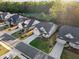 An aerial view showcases the neighborhood, including manicured lawns, tree-lined streets, and proximity to nature at 3825 Raeburn Rd, Cumming, GA 30028
