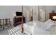 Bright bedroom featuring a four-poster bed, sitting area, and view of ensuite bathroom at 3825 Raeburn Rd, Cumming, GA 30028