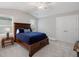 Bedroom with vaulted ceiling, double windows, large bed, and closet with double doors provides a calm and restful space at 3825 Raeburn Rd, Cumming, GA 30028