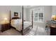 Beautiful primary bedroom featuring a four poster bed, tray ceiling, and plantation shutters at 3825 Raeburn Rd, Cumming, GA 30028