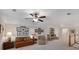 Spacious bonus room featuring a leather sofa and chair, complimented by framed art prints, and a ceiling fan with overhead lighting at 3825 Raeburn Rd, Cumming, GA 30028