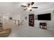 Bright bonus room offers ample space and is adorned with a media center and an open staircase with white painted spindles at 3825 Raeburn Rd, Cumming, GA 30028