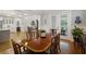 Bright dining room features a wooden table, chairs, hardwood floors, and french doors to outside at 3825 Raeburn Rd, Cumming, GA 30028