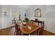 Dining room featuring hardwood floors, wainscoting, and French doors leading to an outdoor space at 3825 Raeburn Rd, Cumming, GA 30028