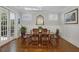 Formal dining room with hardwood floors, wainscoting, and French doors leading to the outside at 3825 Raeburn Rd, Cumming, GA 30028