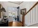 Bright foyer with wood floors, staircase, and a view of the front yard through a glass door at 3825 Raeburn Rd, Cumming, GA 30028