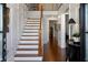Elegant foyer featuring a staircase, wood floors, and paneled walls at 3825 Raeburn Rd, Cumming, GA 30028