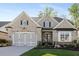 Charming, light brick home featuring a two-car garage and a beautifully landscaped front yard at 3825 Raeburn Rd, Cumming, GA 30028