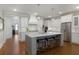 Gourmet kitchen with a large center island, white cabinets, pendant lighting, and stainless appliances at 3825 Raeburn Rd, Cumming, GA 30028