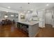 Open concept kitchen with granite countertops, stainless steel appliances, and island with seating at 3825 Raeburn Rd, Cumming, GA 30028
