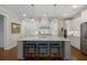 Spacious kitchen features a large center island, white cabinets, pendant lighting, and stainless appliances at 3825 Raeburn Rd, Cumming, GA 30028