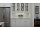 Kitchen space features stainless steel refrigerator, glass display cabinets, and decorative countertop at 3825 Raeburn Rd, Cumming, GA 30028