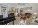 Open-concept living room with a stone fireplace, built-in bookshelves, and hardwood floors at 3825 Raeburn Rd, Cumming, GA 30028