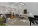 Open-concept living room flows into the kitchen and features large windows and comfortable seating at 3825 Raeburn Rd, Cumming, GA 30028