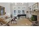 Elegant living room featuring a piano, fireplace, and large windows with plenty of natural light at 3825 Raeburn Rd, Cumming, GA 30028