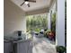 A covered patio with an outdoor seating arrangement offers a tranquil view of the lush, green backyard at 3825 Raeburn Rd, Cumming, GA 30028