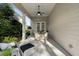 Covered patio with ample seating and a view to the landscaped back yard at 3825 Raeburn Rd, Cumming, GA 30028