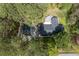 A scenic aerial view reveals a charming home nestled among lush trees, featuring a private driveway and inviting deck at 4220 Smith Rd, Loganville, GA 30052