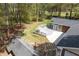 Aerial view of home with deck, wooded backyard, and nearby outbuilding at 4220 Smith Rd, Loganville, GA 30052