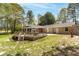 Spacious backyard with a large deck and patio area, ideal for outdoor activities at 4220 Smith Rd, Loganville, GA 30052