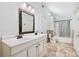 Bright bathroom with a double sink vanity, framed mirror and shower-tub combination at 4220 Smith Rd, Loganville, GA 30052