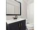 Bathroom featuring a stylish dark vanity, modern fixtures, and a shower-tub combination at 4220 Smith Rd, Loganville, GA 30052