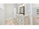 Bright bathroom featuring a double sink vanity with dark bronze fixtures and neutral tile floor at 4220 Smith Rd, Loganville, GA 30052