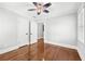 Bedroom with hardwood floors, custom ceiling fan, and neutral colored walls at 4220 Smith Rd, Loganville, GA 30052