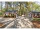 A brick home with an attached garage, adjacent garage, and outbuilding, with a paved driveway at 4220 Smith Rd, Loganville, GA 30052